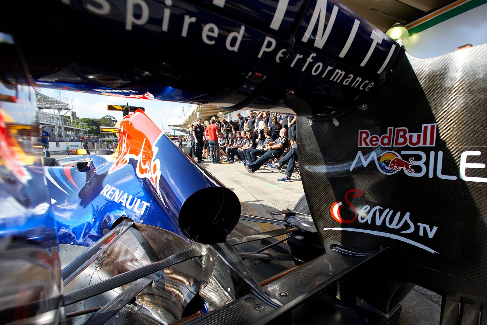 The Red Bull Racing team prepares in the pitlane for the season's final group shot