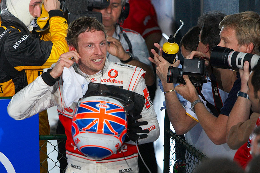 Race winner Jenson Button smiles at the snappers outside parc ferme