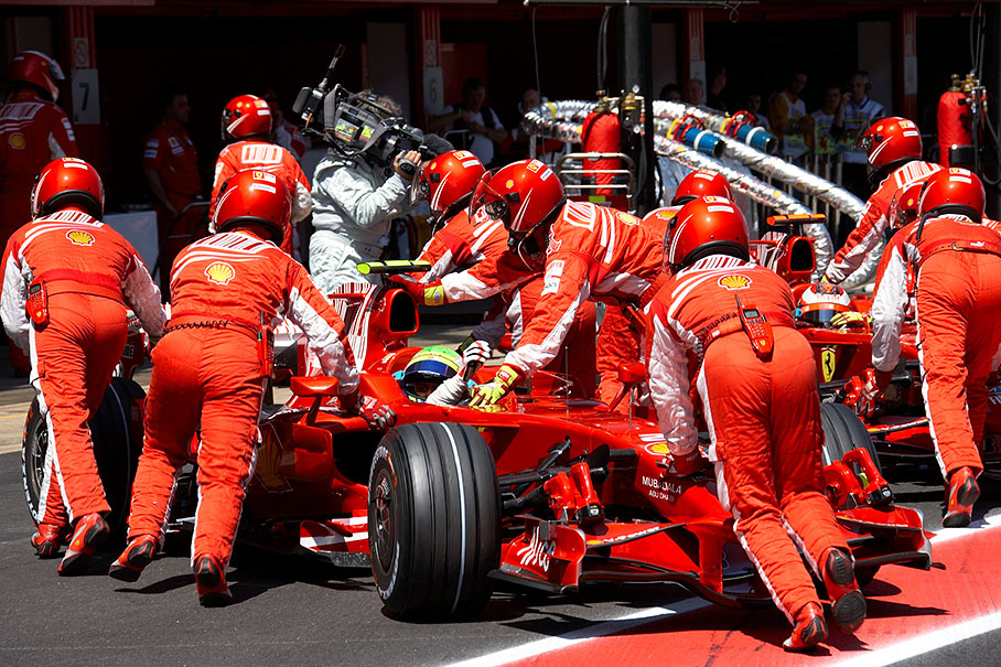 After qualification part 2 both Ferraris are being pushed backwards into pits