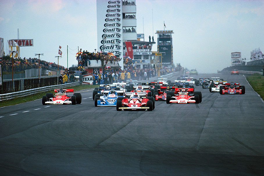 Swiss Ferrari driver Clay Regazzoni has taken the lead at the 1st start for the German Grand Prix 1976. Pole sitter James Hunt (McLaren no. 11) drops back, so as Niki Lauda in the 2nd Ferrari. Jochen Mass in the 2nd McLaren (no. 12) starts on dry weather tyres in the slippery conditions.