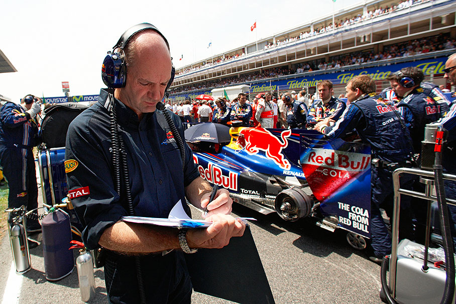 Red Bull's technical director Adrian Newey with a check list besides Vettel's car on the grid's front row