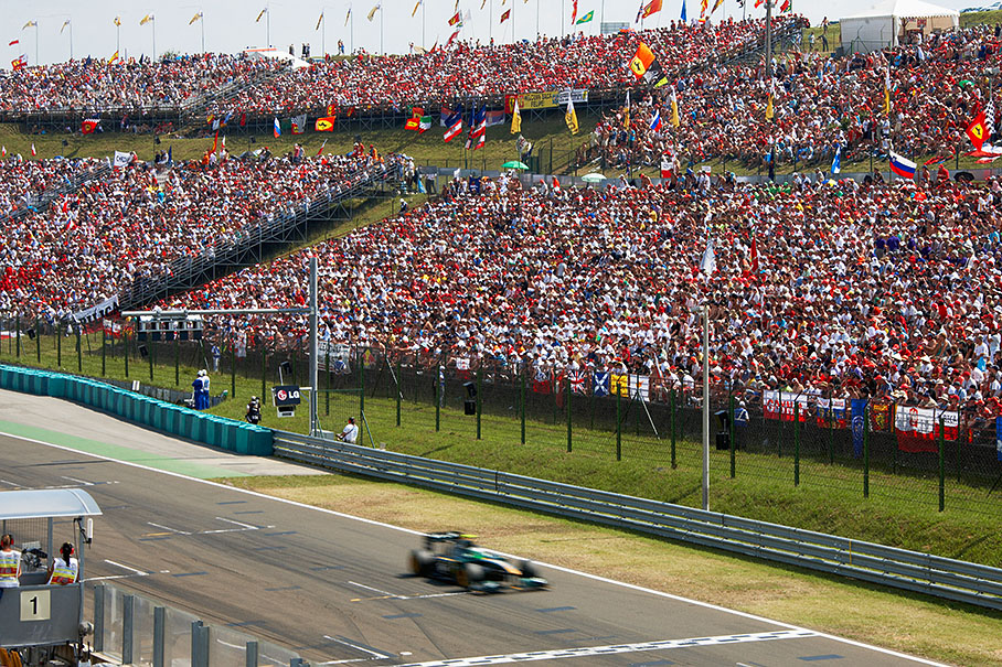 Heikki Kovalainen, Lotus Racing, passes the full grandstands