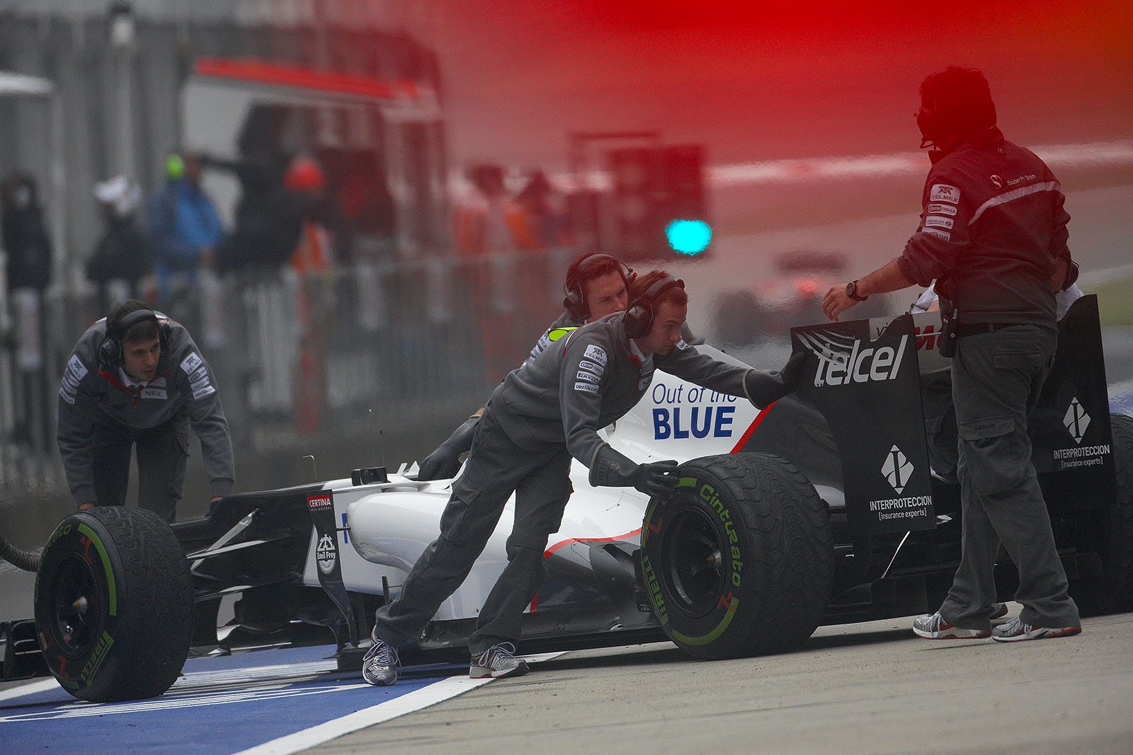 Sergio Perez' Sauber-Ferrari is reversed to pits during the session