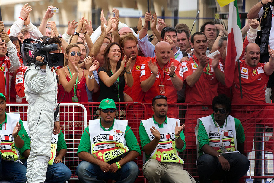 The Ferrari team cheers at parc ferme for the 1-2 winning Ferrari drivers
