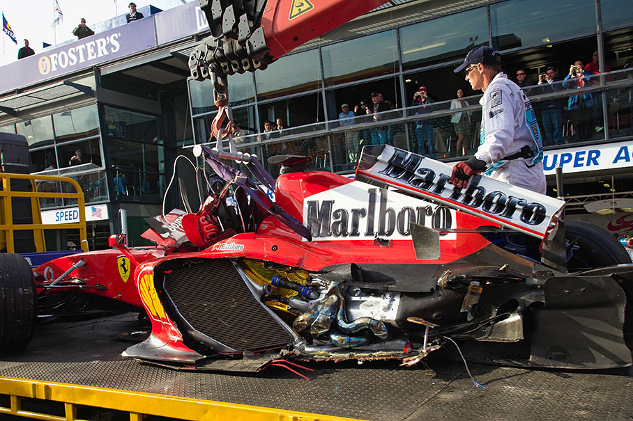 Felipa Massa's crashed Ferrari being returned to the pits