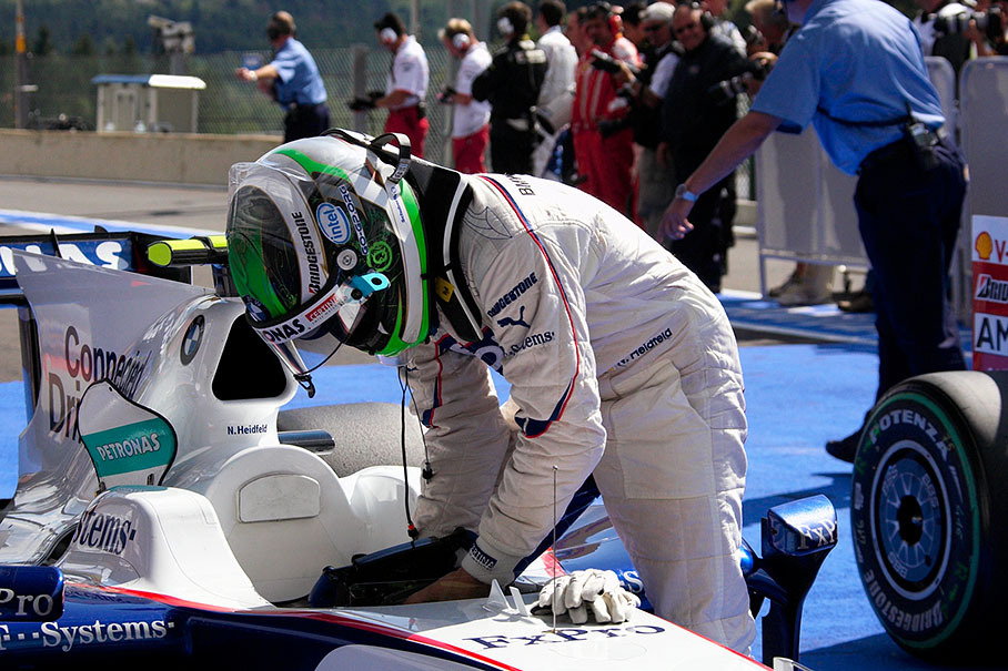 Third grid placed Nick Heidfeld attaches the steering wheel to the BMW Sauber car in parc ferme