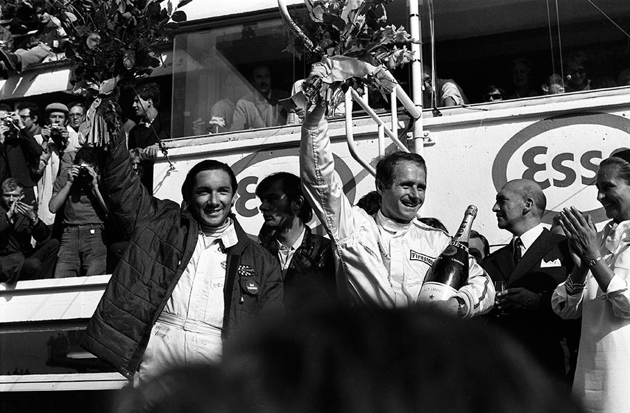 Ford team mates and happy winners Pedro Rodriguez (MEX) and Lucien Bianchi (B) raise their bouquets on podium