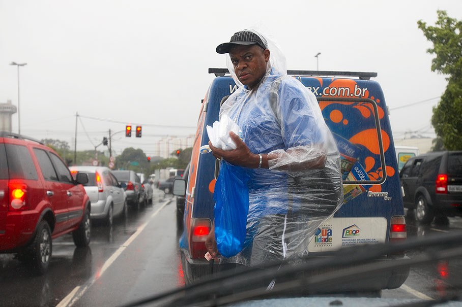A travelling salesman sells rain covers