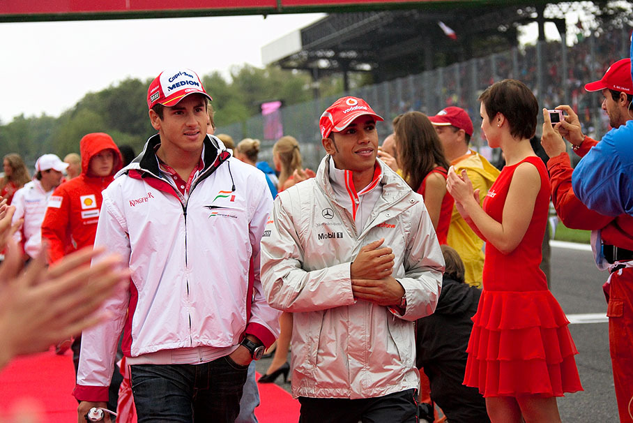 Adrian Sutil and Lewis Hamilton walk to drivers parade