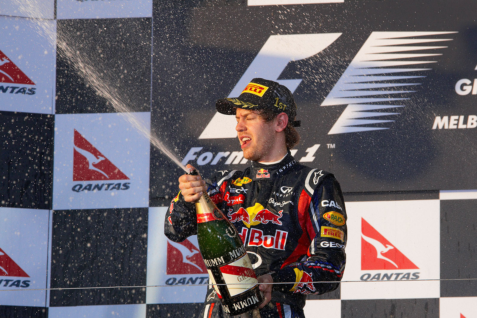 Race winner Vettel sprays champagne after the podium ceremony