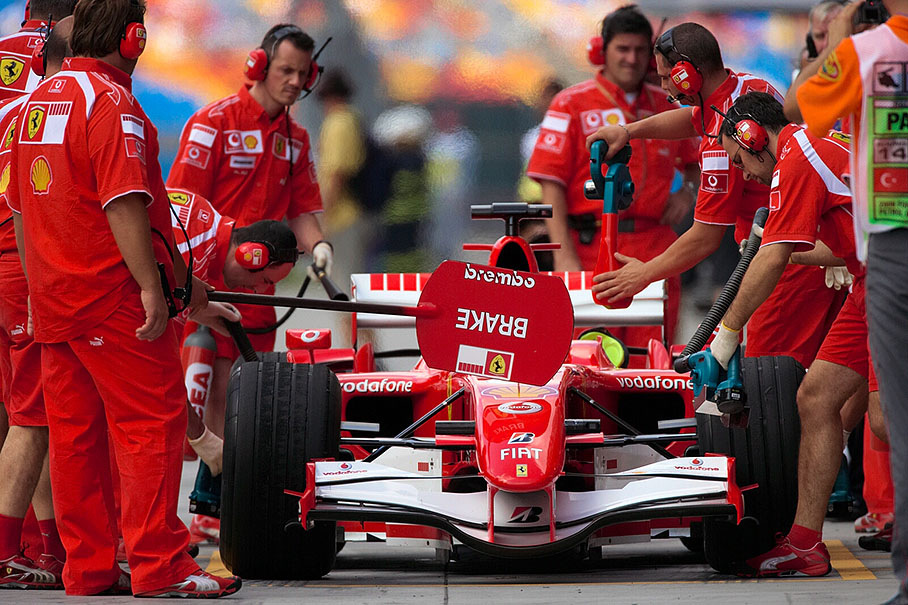 Ferrari mechanics cooling down the brake disks before Schumacher lays some rubber