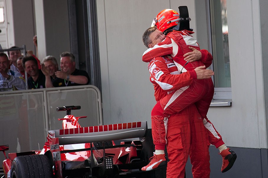 Michael Schumacher jumping at Ross Brawn