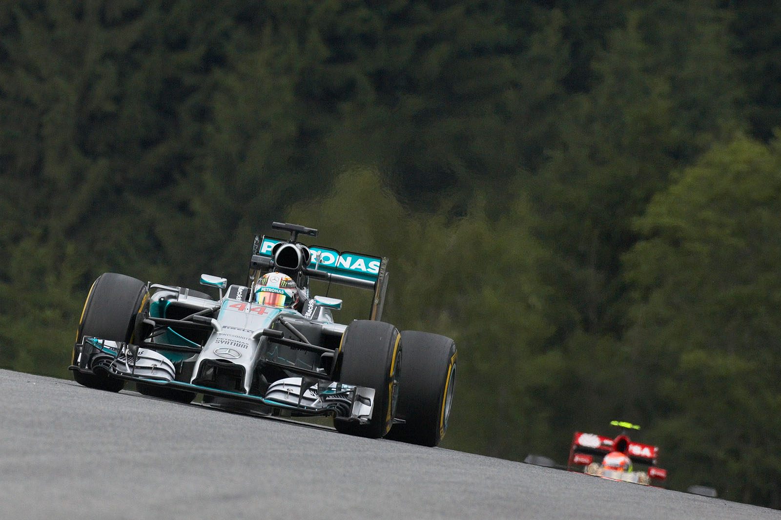 Lewis Hamilton, Mercedes, with Maldonado's Lotus in the background