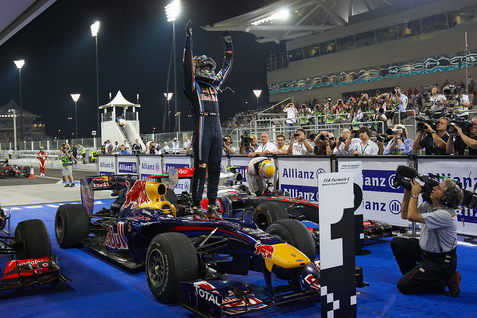Race winner and new World Champion Sebastian Vettel on his car in parc ferme
