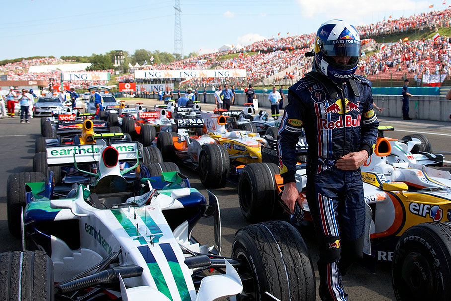 David Coulthard walks through rows of cars in parc ferme after a hot race