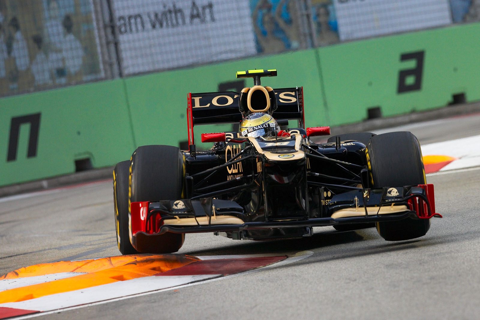 Romain Grosjean, Lotus F1 team, jumps over the curbs