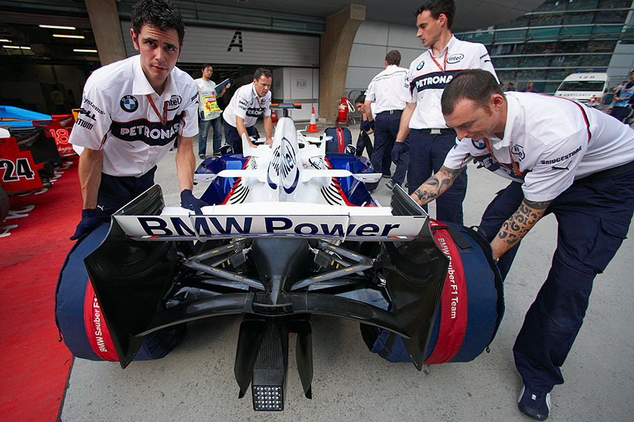 A BMW Sauber car is being fetched from scrutineering at parc ferme