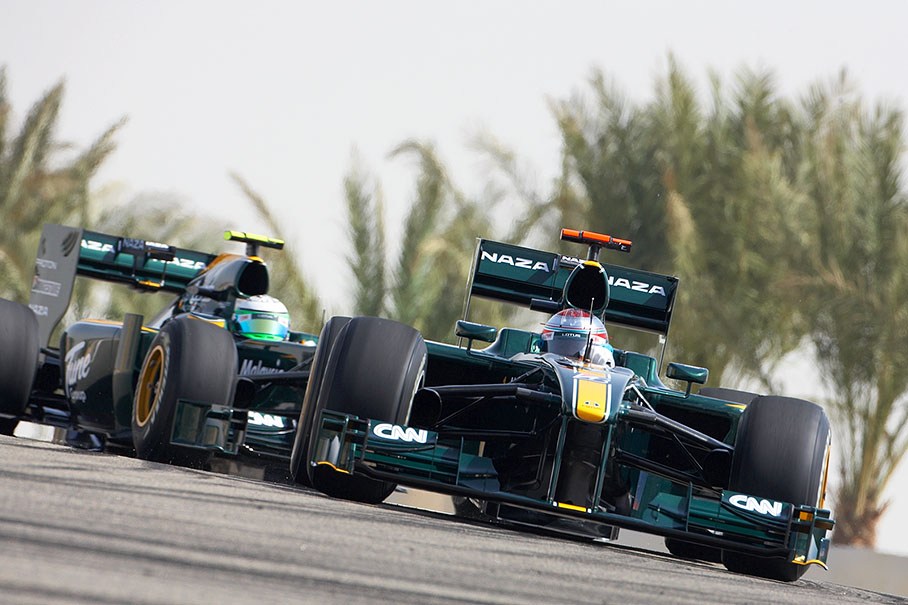Lotus Racing team-mates Jarno Trulli and Kovalainen chase each other on the track