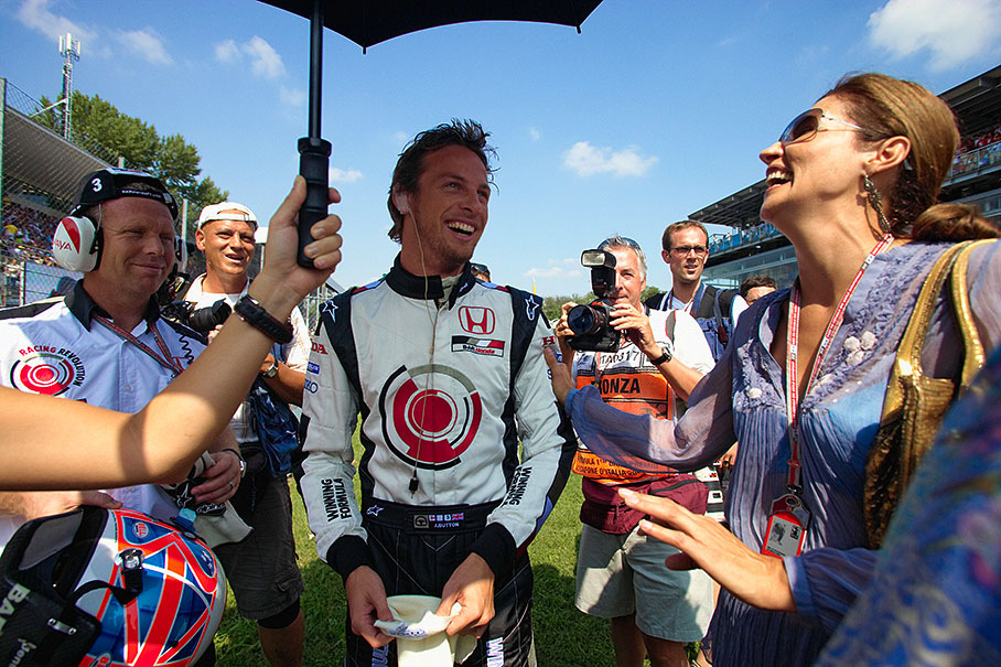 Before the race, Jenson Button jokes around with Bernie Ecclestone's wife Slavica on the grid.