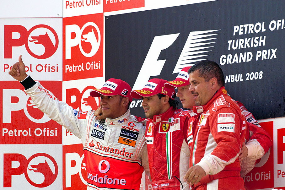 Podium group photo of second placed Lewis Hamilton, winner Felipe Massa, third placed Kimi Raikkonen and Ferrari's chief engineer Francesco Uguzzoni