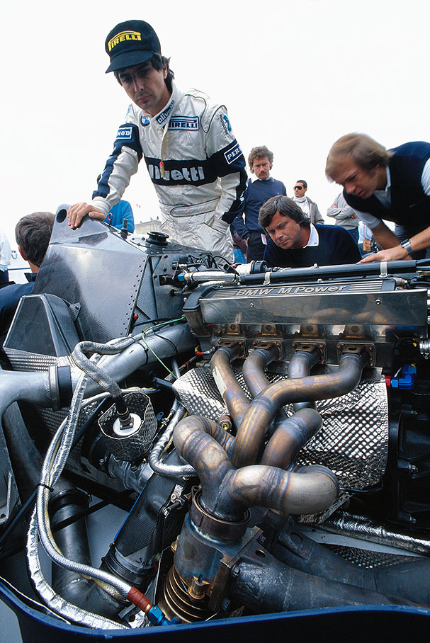 Brazilian Brabham driver Nelson Piquet looks closely at his 1.5 litres BMW turbo engine (1.5 t/c Brabham BT54-BMW 4)