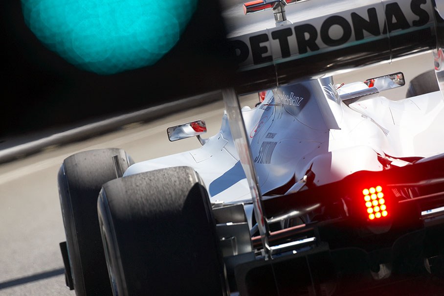 Michael Schumacher, Mercedes GP, passes the green signals at pit lane exit