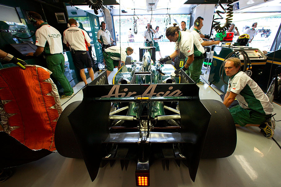 Jarno Trulli's car is returned to caring Lotus Racing mechanics