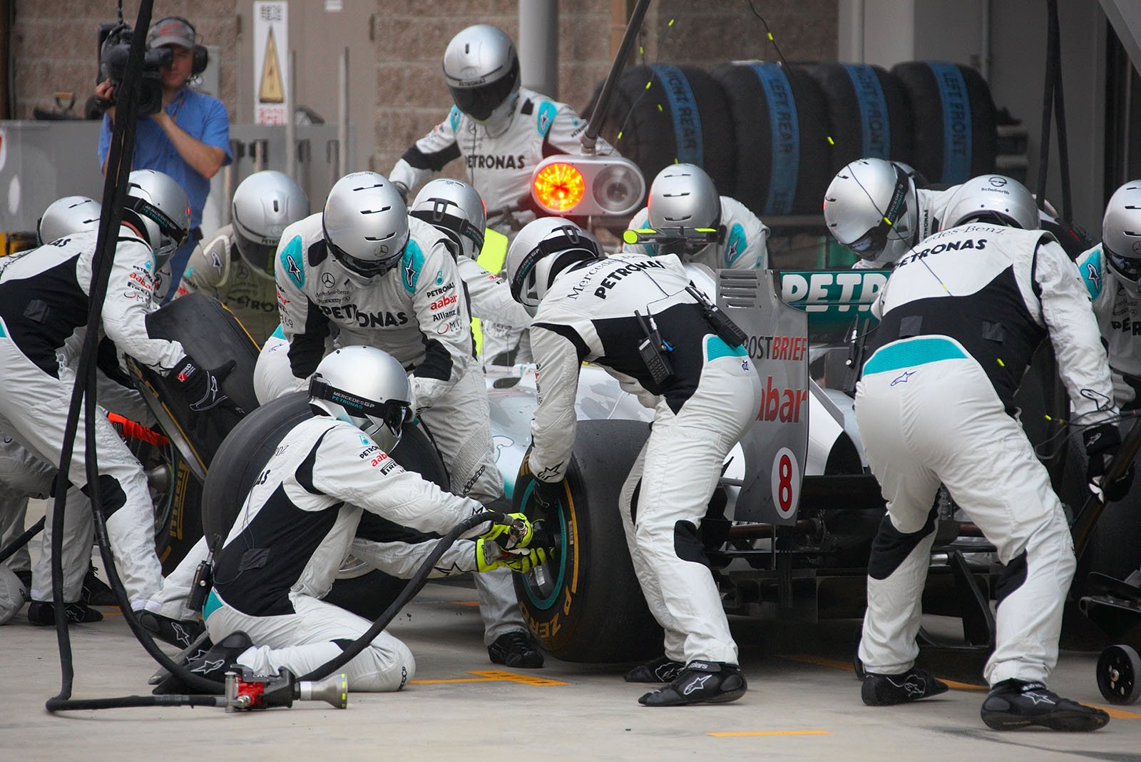 Rosberg's Mercedes is serviced at Mercedes Grand Prix pits