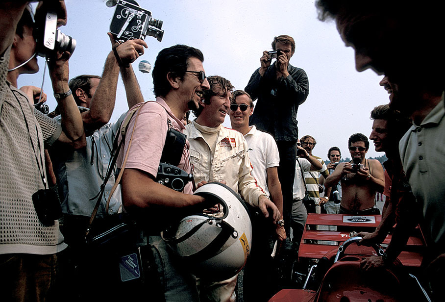 Race winner Jochen Rindt poses behind the Lotus-Cosworth 72C, now leading the championship