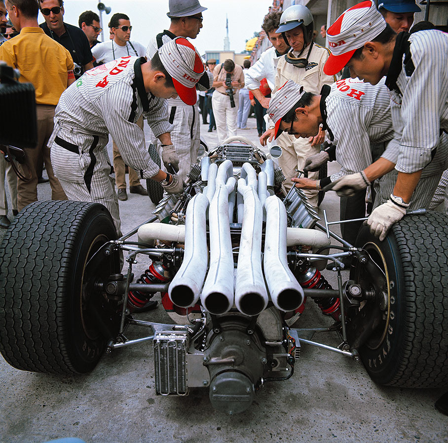 Richie Ginther stands besides his Honda.