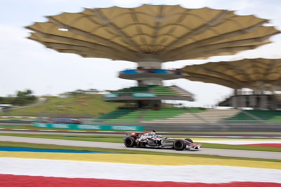 Juan Pablo Montoya passing the impressive Sepang track landmarks