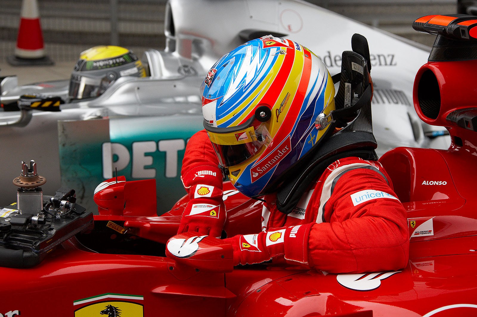Ferrari's fifth grid positioned Fernando Alonso in parc ferme after qualifying besides fourth placed Rosberg