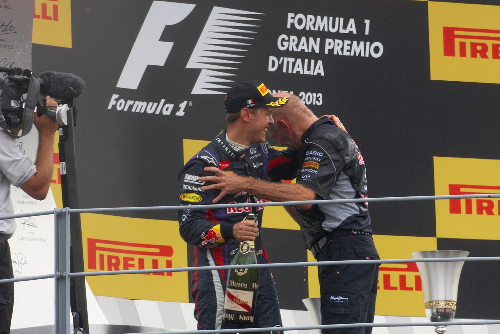 RBR's race winner Sebastian Vettel sprays champagne at Adrian Newey during the podium ceremony after the Italian Grand Prix in Monza 2013