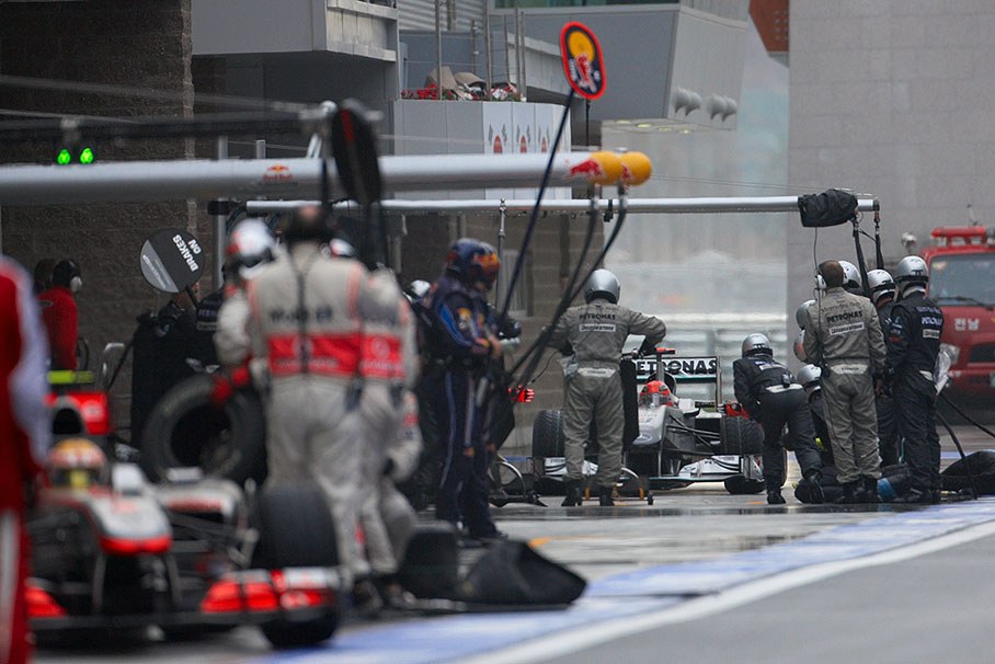 Michael Schumacher, Mercedes GP, pits behind McLaren's Hamilton