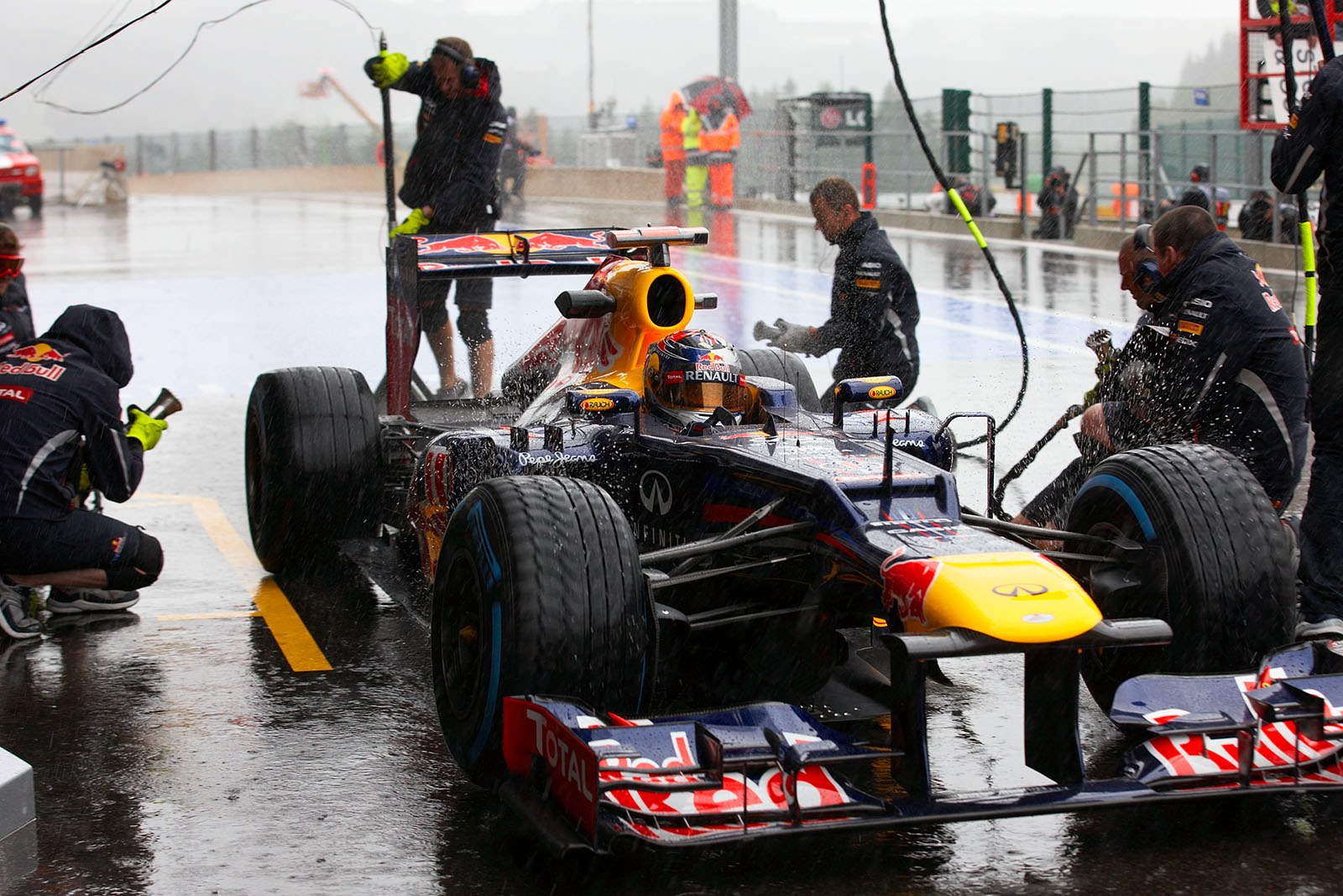 Sebastian Vettel comes to Red Bull pits and tests a stop under heavy rain