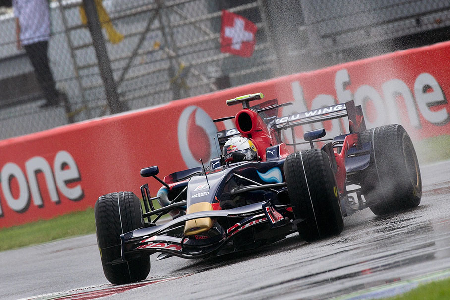 Sebastian Vettel slides with his Toro Rosso at first chicane