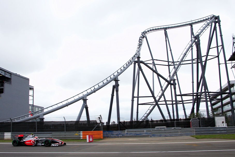 Heikki Kovalainen, McLaren Mercedes, passes a new landmark, a part of the new fast roller coaster rail system