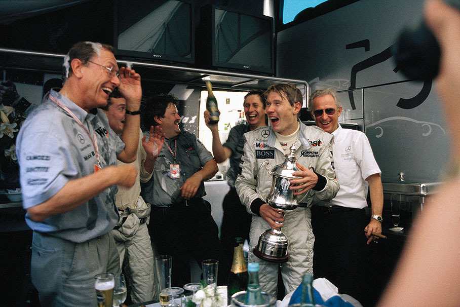 Mika Hakkinen celebrates his first ever victory in the season's last race with his team-mates and company principals. From left to right: Juergen Schremp of Mercedes, David Coulthard, Norbert Haug, Mario Illien, Mika Hakkinen and Juergen Hubbert of Mercedes.