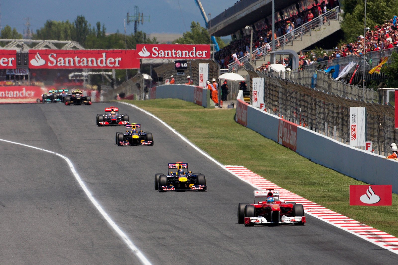 Fernando Alonso's Ferrari leads the pack during the first stint.