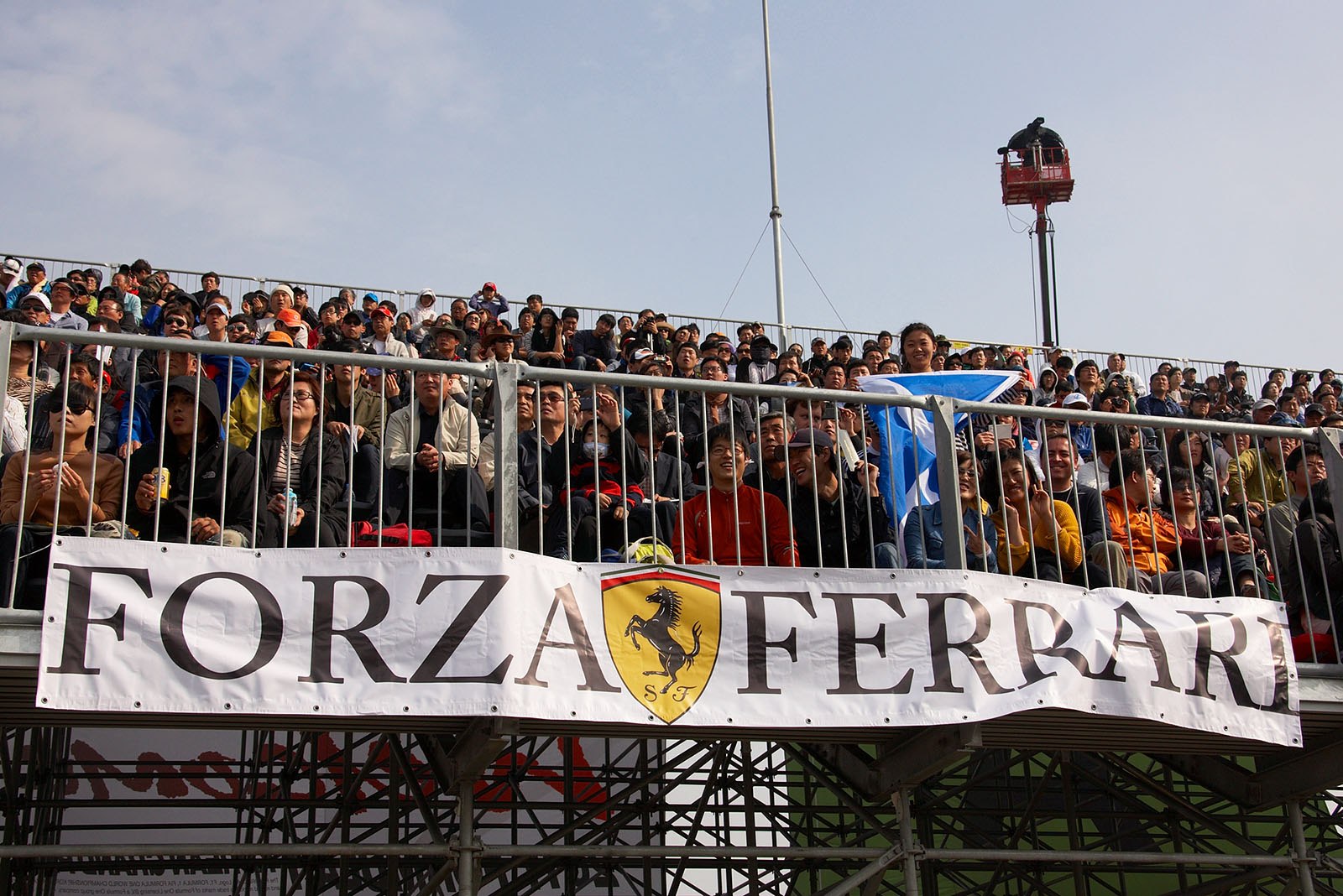 A Ferrari fan banner on a stand