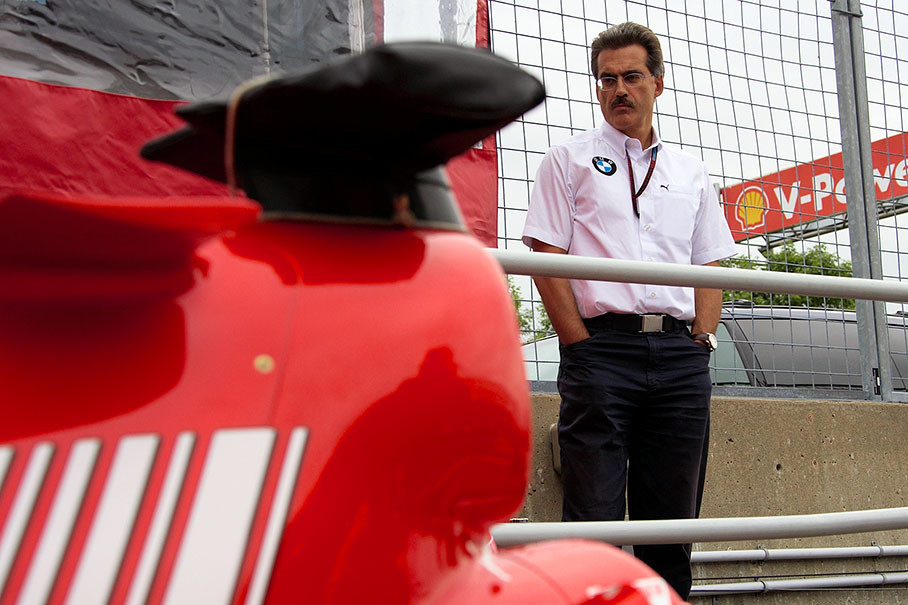BMW Motorsport director Dr. Mario Theissen watches a Ferrari being scrutineered