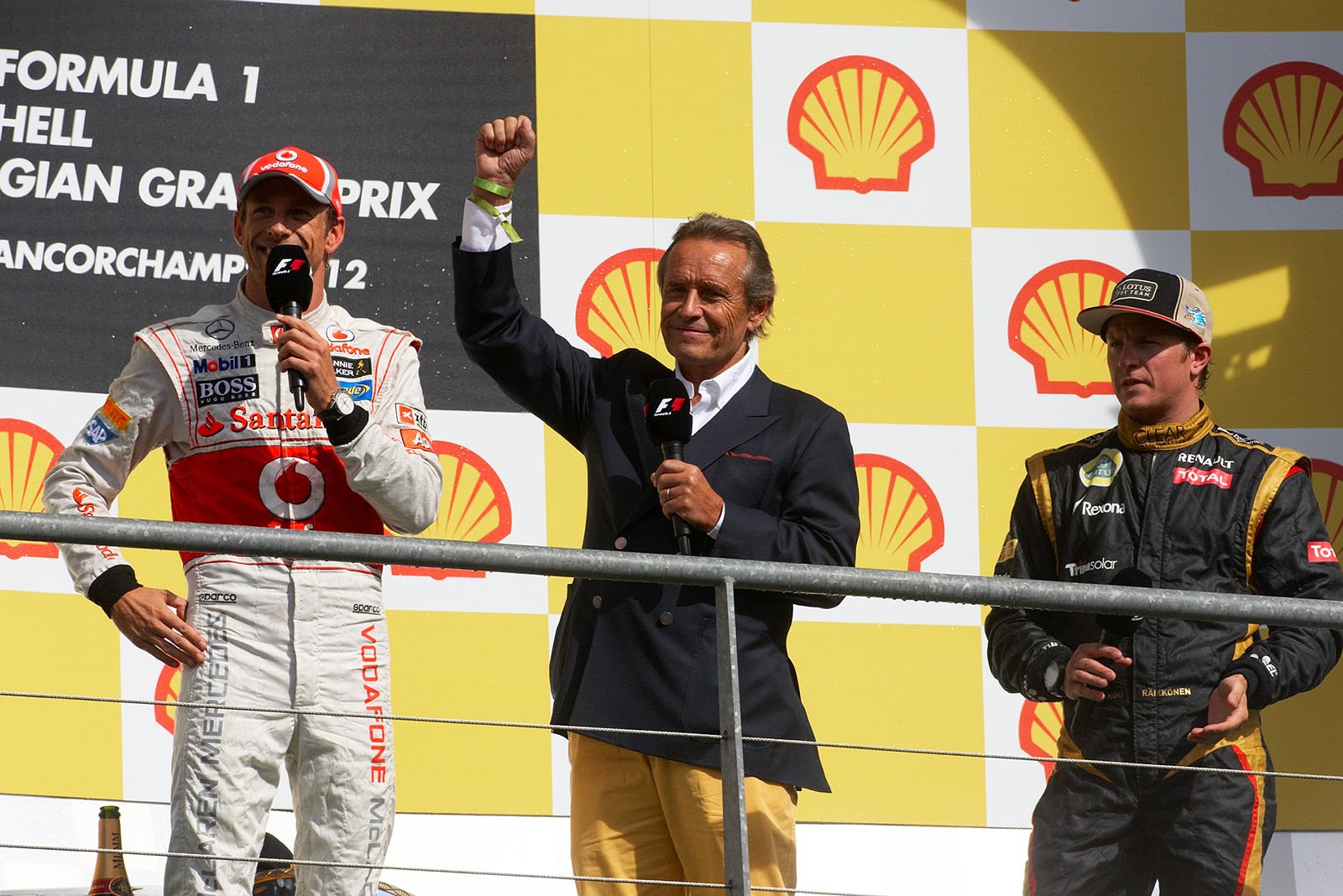 Belgian racing legend Jacky Ickx interviews the drivers on the podium after the ceremony