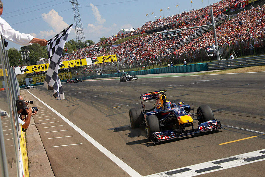Mark Webber, Red Bull Racing, takes the chequered flag and wins the 2010 Hungarian GP, now leading the Driver's World Championship after round 12 with 161 points