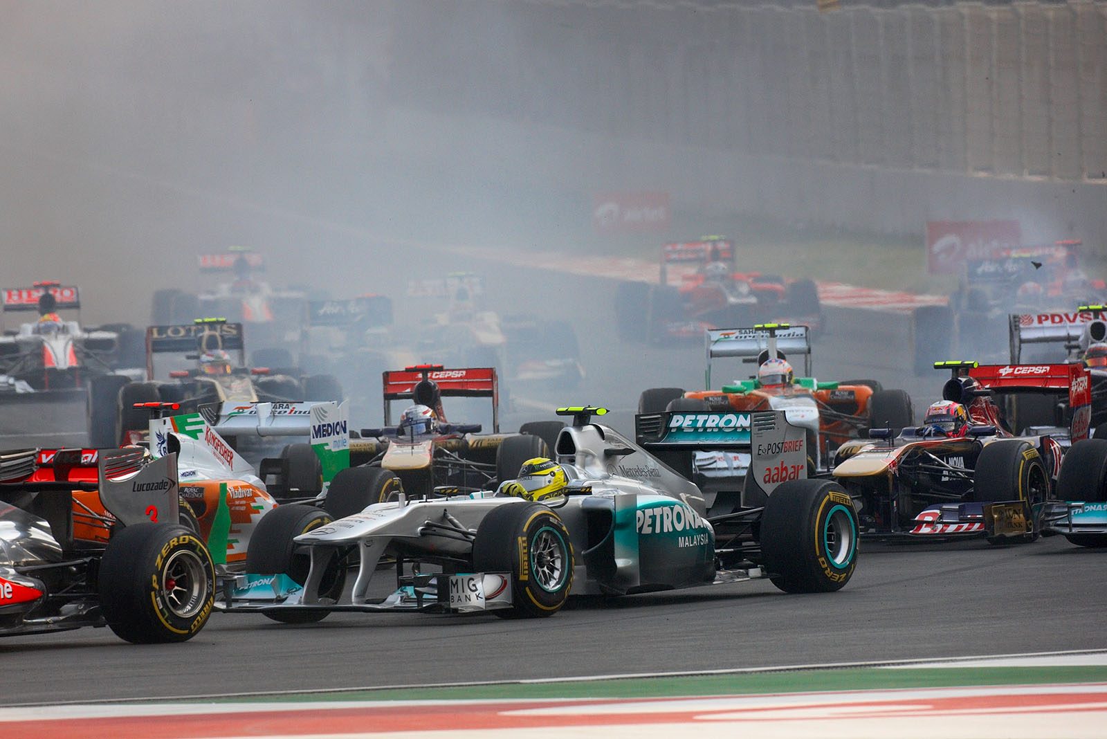 Nico Rosberg of Mercedes GP in the middle of the field in turn one