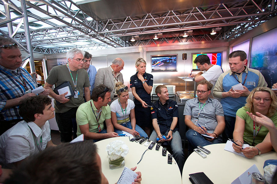 Red Bull's sunnyboy Sebastian Vettel surrounded by the international press