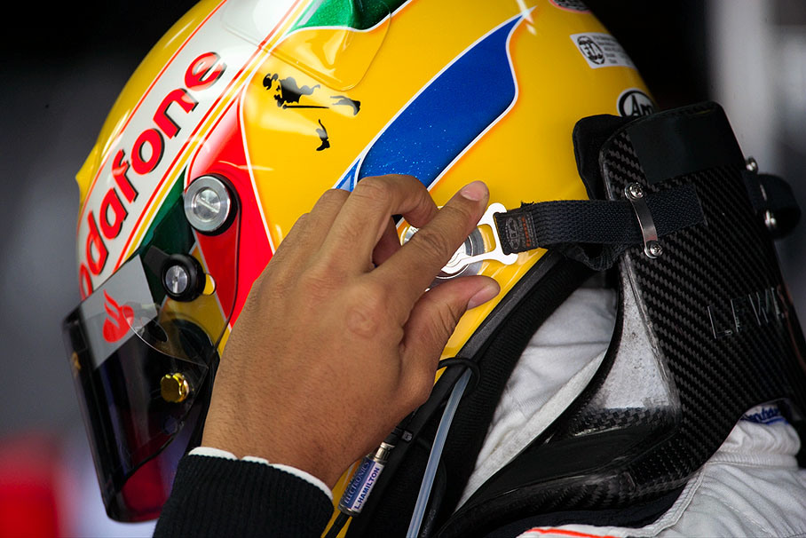 Lewis Hamilton attaches his helmet to the HANS device