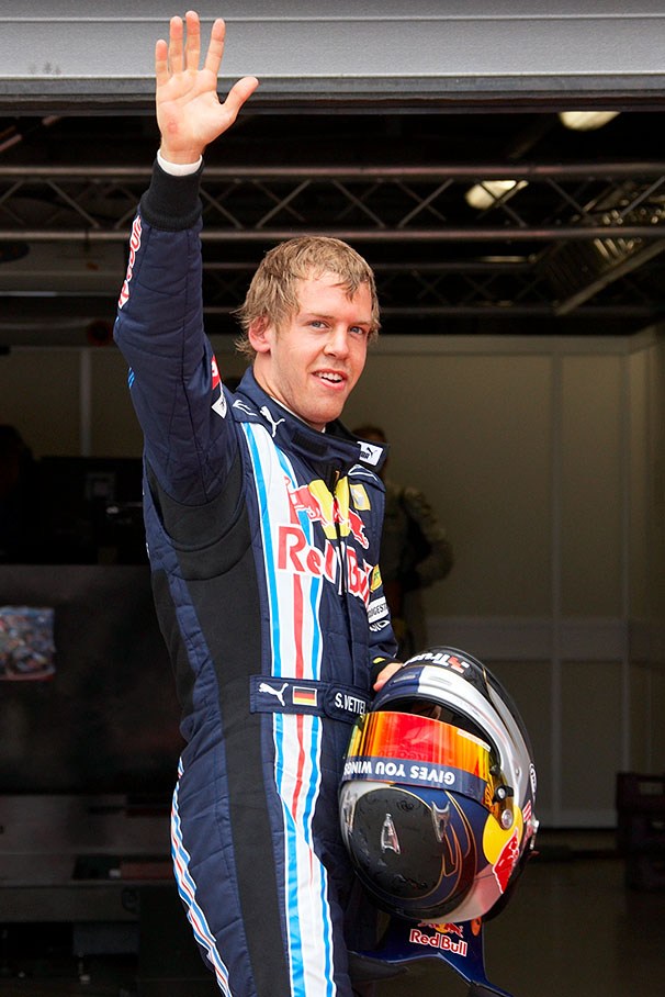 Polesetter Sebastian Vettel waves at the fans