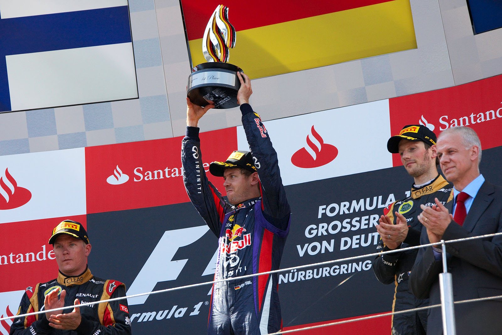 Race winner Sebastian Vettel of Red Bull Racing presents his winning drivers trophy, celebrating a victory at his home Grand Prix for the first time