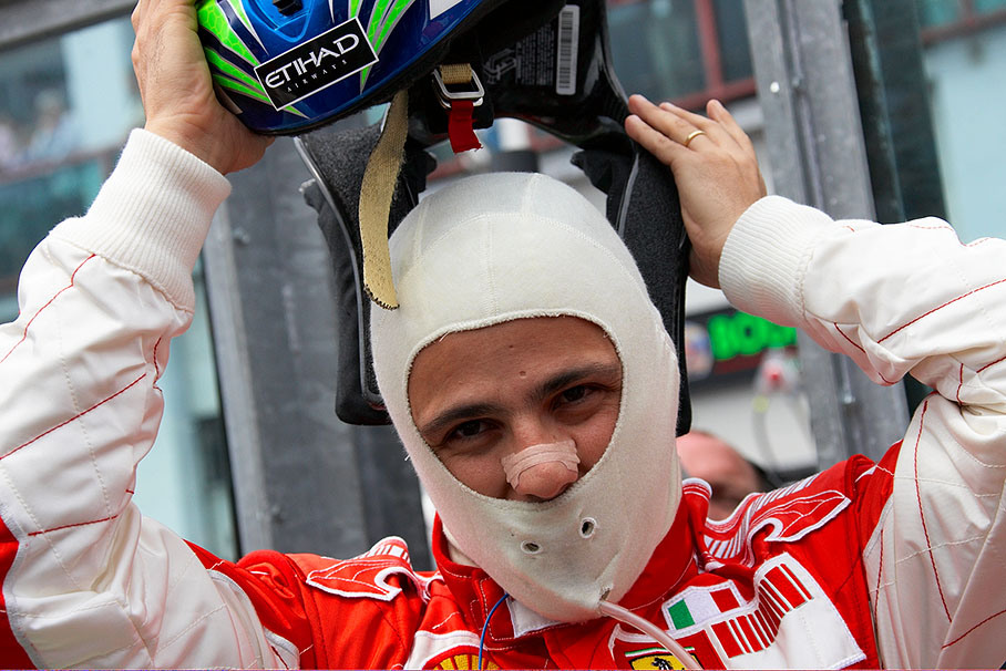Felipe Massa puts his helmet on