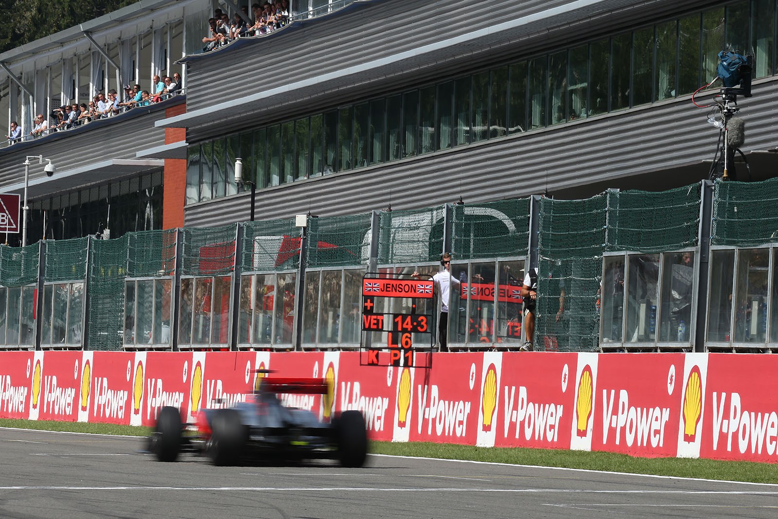 Jenson Button, McLaren Mercedes, passes his pit board